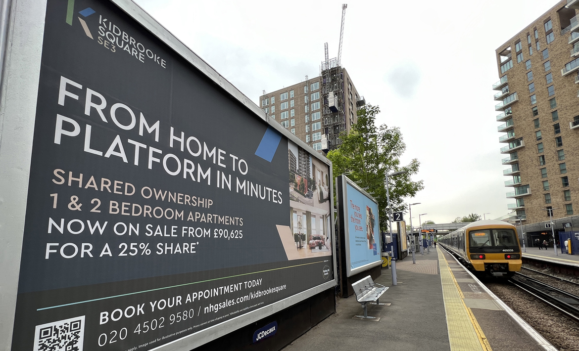 Looking along Kidbrooke Train Station with a Southeastern train arrived at the platform. Kidbrooke Square signage on show.