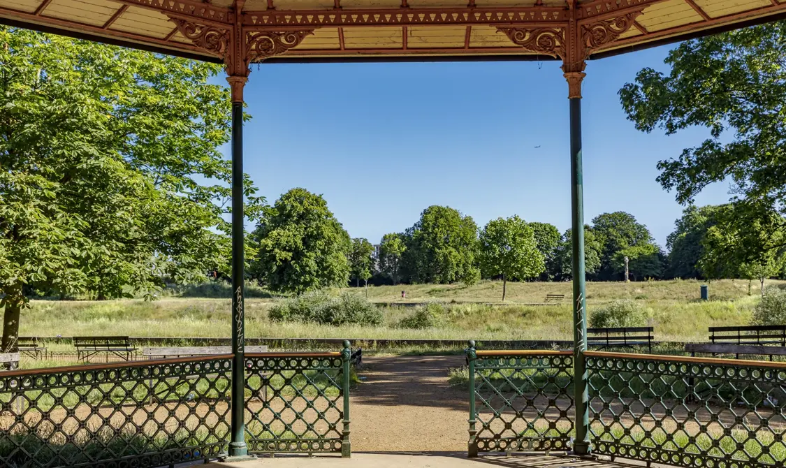 A tranquil park surrounded by trees and greenery.