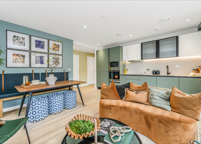 A stylish open-plan living, kitchen and dining area featuring a built-in bench seating and curved sofa.
