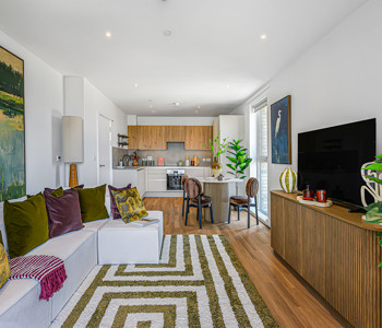 An open-plan apartment with contemporary interior and large windows providing plenty of natural light.
