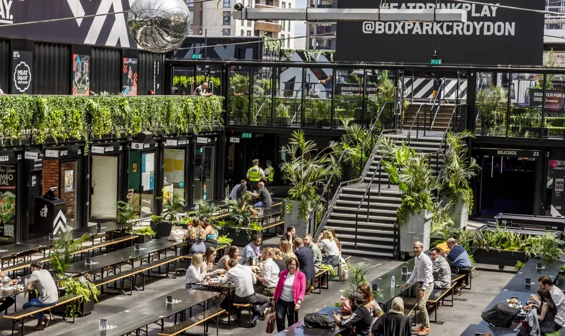 People eating and socialising at BOXPARK Croydon.